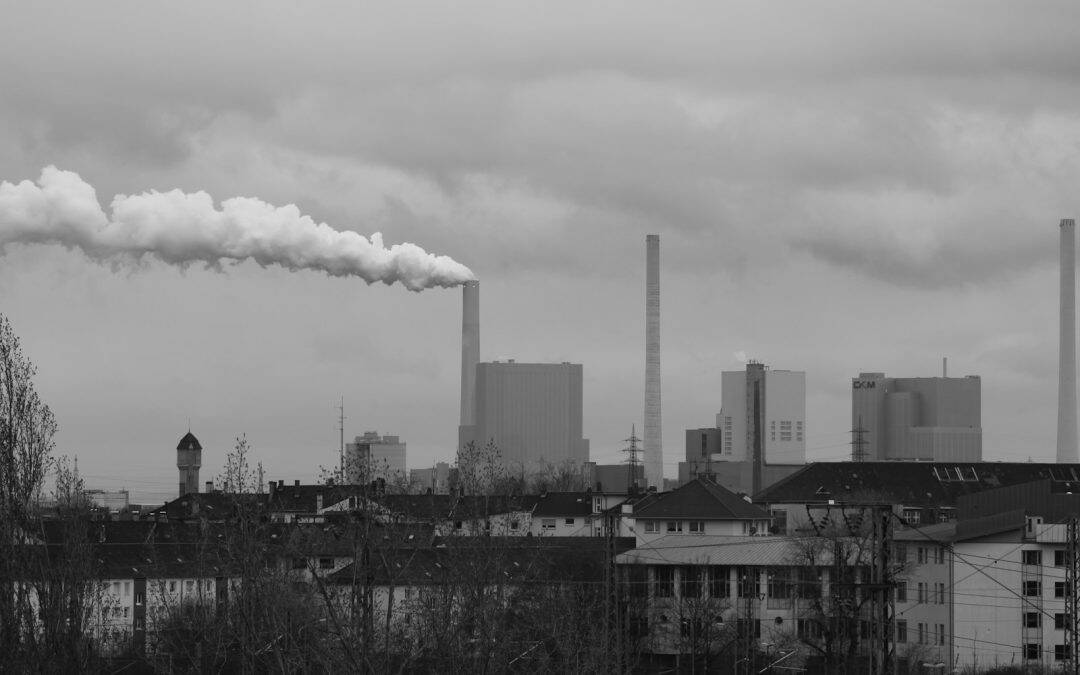 grayscale photo of city buildings under cloudy sky